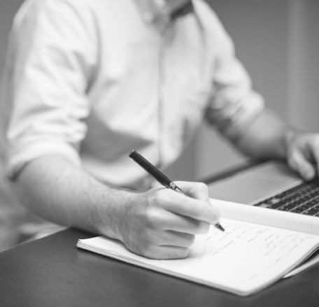 Man writing on a notepad